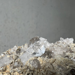 Hand holding a Double Terminated "Diamond" Quartz from Pakistan against a dark background