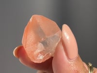 
                
                    Load and play video in Gallery viewer, video of Hand holding a rough brazilian peach lemurian quartz against a dark background
                
            