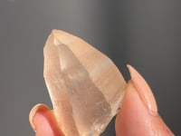 
                
                    Load and play video in Gallery viewer, video of Hand holding a rough brazilian peach lemurian quartz against a dark background
                
            