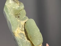 
                
                    Load and play video in Gallery viewer, video of Hand holding a green Epidote in Prehnite from Namibia against a gray background
                
            